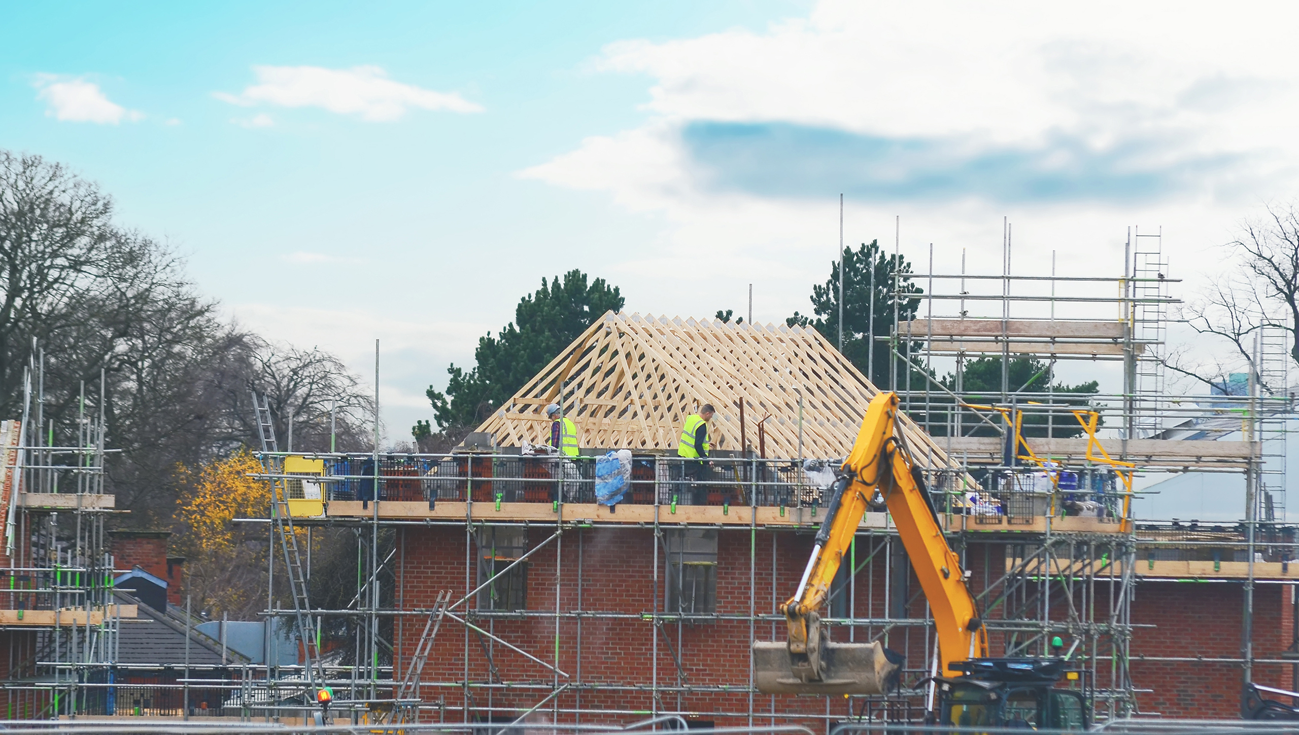 Roofers at work, installation of a new covering of a tiled roof. Working of scaffold platform